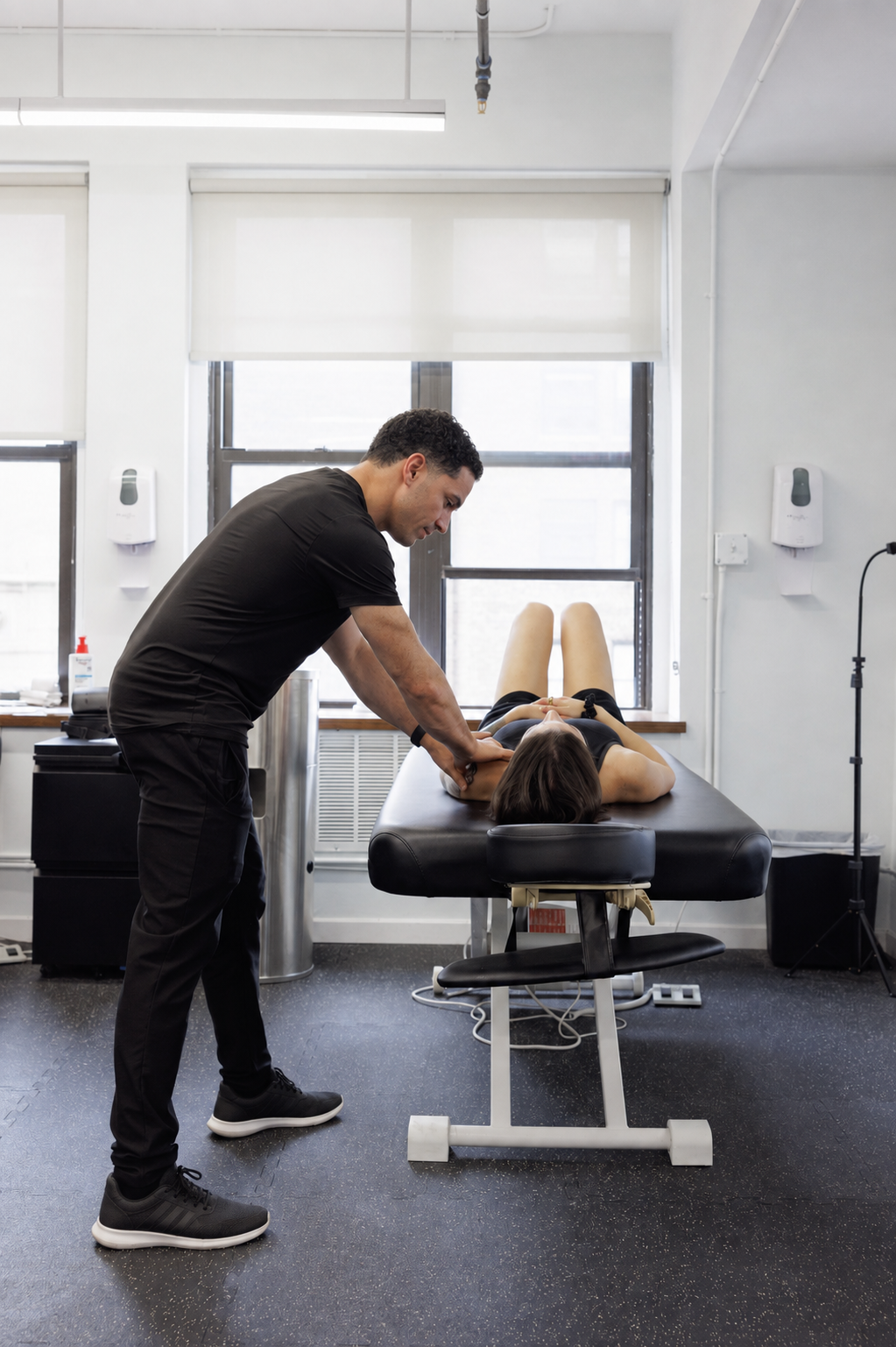 Physical therapist performing manual therapy on a patient's leg at Neuromatrix in New York City